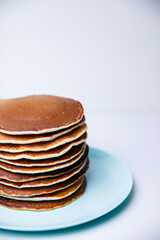 Stack of Tasty pancakes on white background