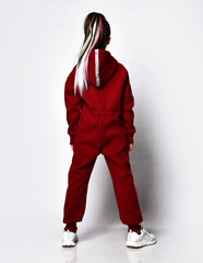 Caucasian pretty preteen girl model with trendy hairstyle dressed sportswear tracksuit posing for...