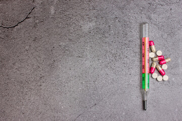Tablets in capsules. Medical treatment of diseases. A tool for measuring temperature.