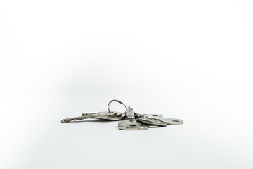 a bunch of metal keys on a white background