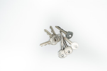 a bunch of metal keys on a white background
