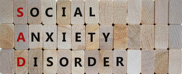 SAD, social anxiety disorder symbol. Concept words 'SAD, social anxiety disorder' on cubes on a wooden background. Medical, psychological and SAD, social anxiety disorder concept. Copy space.
