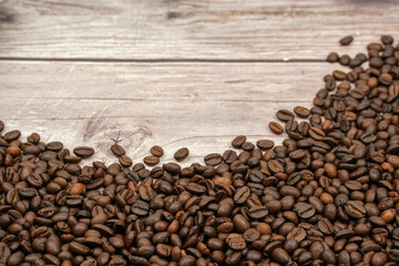 Coffee beans on wood background	
