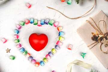 Various colored paper folded in the shape of a rabbit arranged in a heart with a red heart on a white background.	
