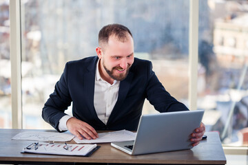 Adult successful male businessman, teacher, mentor is working on a new project. Sits at the table...