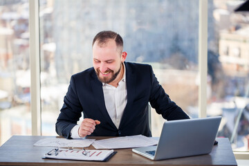 Adult successful male businessman, teacher, mentor is working on a new project. Sits at the table...