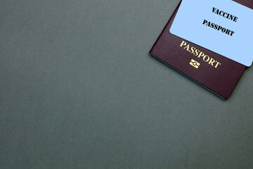 A British Passport With A Vaccine Passport Resting On Top. Travelling Abroad Concept.