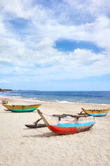 Fototapeta na wymiar Small fishing boats on an empty beach, Sri Lanka.