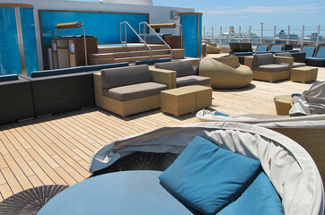 Elegant and modern lounge furniture sun loungers and deck chairs on open outdoor sun deck of luxury...