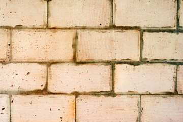 Texture of a brick wall with cracks and scratches which can be used as a background