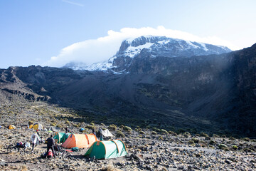 A campsite on Mount Kilimanjaro on a bright day with a hint of fog.
