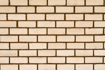Texture of a brick wall with cracks and scratches which can be used as a background