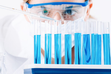 laboratory assistant in a laboratory with test tubes produces vaccine samples. Development of...