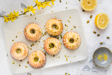 Homemade delicious mini lemon bundt cakes (muffins) on white background, top view
