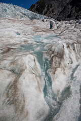 A clear stream of alpine water flowing through Franz Josef glacier.