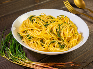 Plate of spaghetti with agretti. Typical mediterranean cuisine in the spring season. Cooked salsola soda, this vegetable also known as barilla plant, barba di frati, friar's beard or monk's beard.