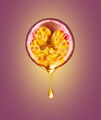 A drop of juice drips from half a passion fruit close up on purple background