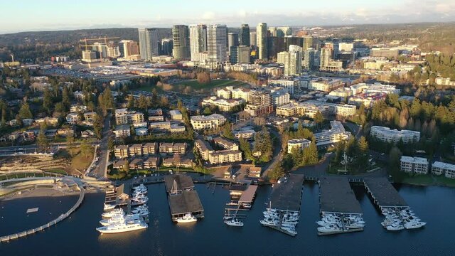 Cinematic aerial sunset drone trucking footage of Meydenbauer Bay Park, Clyde, Eastland, beach park, marinas with Lake Washington Whalers Cove waterfront mansions in Belleview near Seattle, Washington