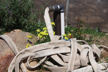 Close view of a piled up water hose