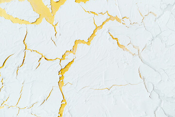 Beautiful white background of decorative plaster with yellow veins. 