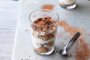 Individual portion of tiramisu dessert in the glass