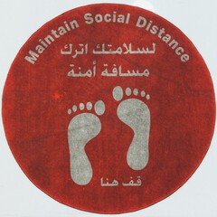 Dirty footworn round red colored sign MAINTAIN SOCIAL DISTANCE, coronavirus disease COVID-19 warning sign written in both in Arabic and English on the floor of shopping mall