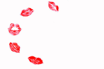 White background with prints of red lipstick