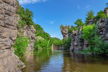Fototapeta na wymiar Beautiful river in rocky canyon among green nature. Perfect place for climbing. Landscape of Buky canyon, Ukraine