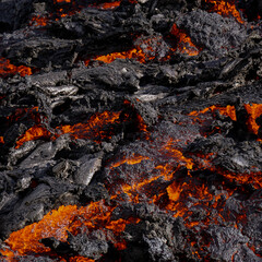 Red-hot, molten lava flows from a small volcanic eruption in Mt Fagradalsfjall, Southwest Iceland....