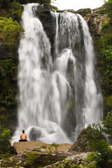 Man contemplating the waterfall (Cachoeira dos Garcias, MG, Brazil)
