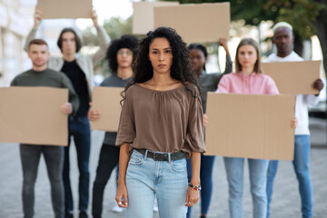 Active woman leading a group of demonstrators on the street