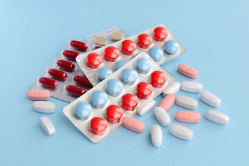Pharmaceutical medicine pills over blue background. 