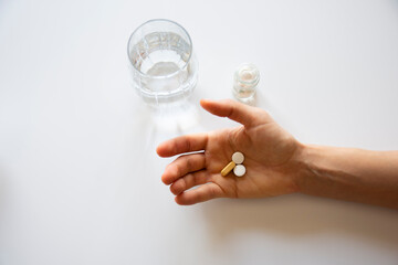 man holding medicine and a glass of water. selective Focus. isolated
