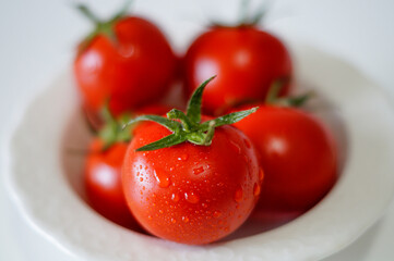 Fresh organic tomatoes in a white bowl