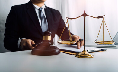 Business and lawyers discussing contract papers with brass scale on desk in office. Law, legal...