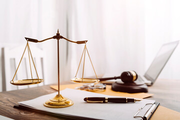 Justice and law concept.Male judge in a courtroom with the gavel, working with, computer and...