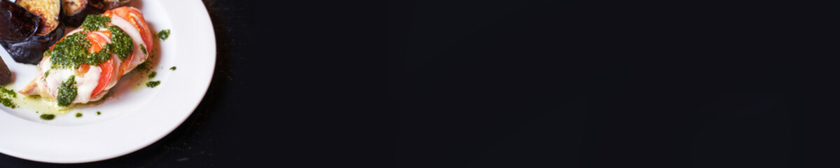 Summer healthy food. Cheese, tomato, basil and eggplant reciepe. Mozzarella sliced oven. Homemade dinner. Cafe italian meal. Diet cooked lunch. Horizontal banner. Copyspace. Black background