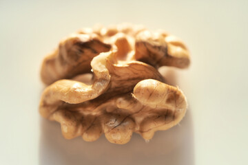 Closeup macro photo of isolated chopped highest quality raw walnut and walnut shell in white background