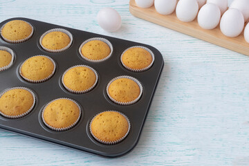the vanilla muffins are cooled in a baking dish. Confectionery form. Fresh homemade baking concept. High quality photo. Freshly baked bran muffins cooling down in baking tin