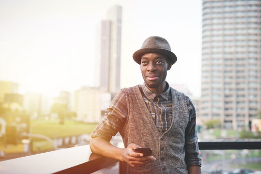 Young black man outdoor holding smartphone