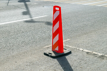 Portable post for prohibiting traffic on the road