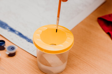 Brush and glass of water. Drawing with watercolors.