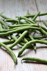 green beans, green vegetables, beans scattered on a wooden background