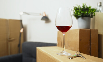 Keys and a glass of red wine in a new apartment.
