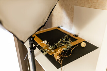 Amateur simple home made mini photo studio in the apartment. Inexpensive self made background in the photo studio. Herbarium, items, backrounds for a photo session. 