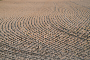 Naklejka premium Furrows row pattern in a plowed field at springtime
