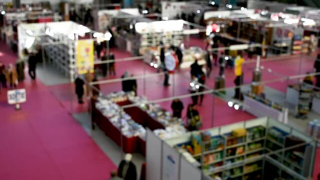 Blurred top view of book fair walking visitors