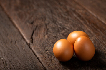 Brown chicken eggs rises on the table.