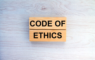 Wooden blocks with text Code of Ethics on the wooden background
