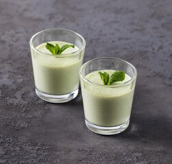 Vegan dessert creamy jelly green mint in a glass on a dark background